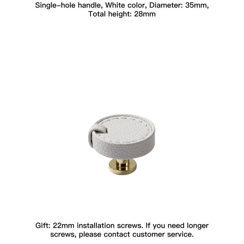 White leather round decorative drawer pull with gold hardware.